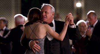 Movie still from “Meet Joe Black” (1998), directed by Martin Brest – An older man and a young woman dancing together; Medium shot, Low angle
