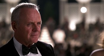 Movie still from “Meet Joe Black” (1998), directed by Martin Brest – An older man wearing a tuxedo and a bow tie; Close Up shot, Over the shoulder angle