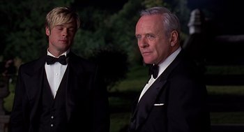 Movie still from “Meet Joe Black” (1998), directed by Martin Brest – Two men in tuxedos standing next to each other; Medium shot, Over the shoulder angle