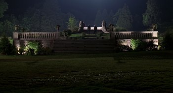 Movie still from “Meet Joe Black” (1998), directed by Martin Brest – Three people are sitting on steps at night; Extreme Wide shot, High angle