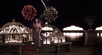 Movie still from “Meet Joe Black” (1998), directed by Martin Brest – A woman standing in front of fireworks at night; Wide shot, Low angle