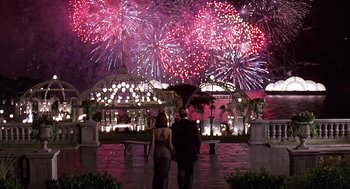Movie still from “Meet Joe Black” (1998), directed by Martin Brest – A man and a woman are looking at a fireworks display; Extreme Wide shot, Low angle
