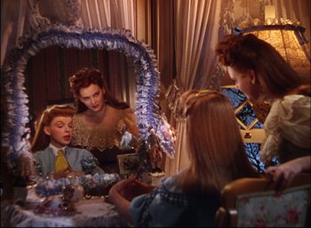 Movie still from “Meet Me in St. Louis” (1944), directed by Vincente Minnelli – Two women and a boy in front of a mirror; Medium shot, Over the shoulder angle