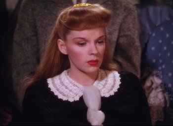 Movie still from “Meet Me in St. Louis” (1944), directed by Vincente Minnelli – A person wearing a dress; Close Up shot, High angle