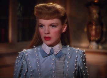 Movie still from “Meet Me in St. Louis” (1944), directed by Vincente Minnelli – A woman in a blue dress with a white collar; Close Up shot, Low angle