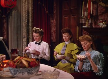 Movie still from “Meet Me in St. Louis” (1944), directed by Vincente Minnelli – A group of people sitting around a table eating; Medium shot, High angle