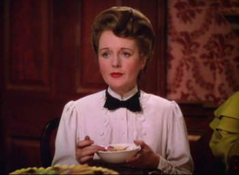 Movie still from “Meet Me in St. Louis” (1944), directed by Vincente Minnelli – A woman sitting at a table with a bowl of cereal; Close Up shot, Over the shoulder angle