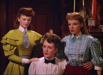 Movie still from “Meet Me in St. Louis” (1944), directed by Vincente Minnelli – A group of women standing next to each other in a room; Medium shot, Low angle