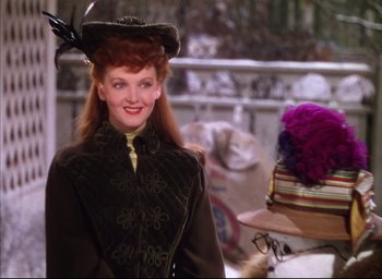 Movie still from “Meet Me in St. Louis” (1944), directed by Vincente Minnelli – A person wearing a hat and a coat; Medium shot, Over the shoulder angle