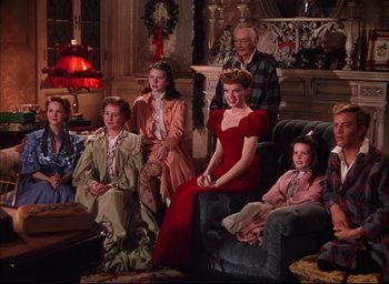 Movie still from “Meet Me in St. Louis” (1944), directed by Vincente Minnelli – A group of people sitting in a living room together; Wide shot, High angle