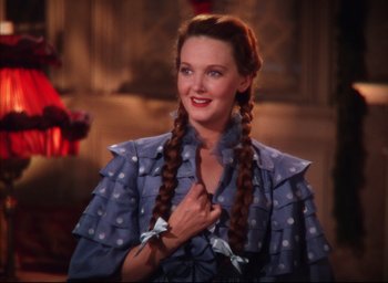 Movie still from “Meet Me in St. Louis” (1944), directed by Vincente Minnelli – A woman with long braids wearing a blue dress; Close Up shot, High angle
