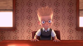 Movie still from “Meet the Robinsons” (2007), directed by Stephen J. Anderson – A cartoon of a boy sitting at a table with his hands on his knees; Medium shot, High angle