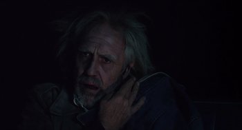 Movie still from “Melvin and Howard” (1980), directed by Jonathan Demme – An old man with long white hair is holding a cell phone to his ear; Close Up shot, Low angle