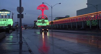 Movie still from “Melvin and Howard” (1980), directed by Jonathan Demme – A truck driving down a street near a neon sign; Extreme Wide shot, Low angle