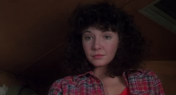 Movie still from “Melvin and Howard” (1980), directed by Jonathan Demme – A person with curly hair wearing a plaid shirt; Close Up shot, Low angle