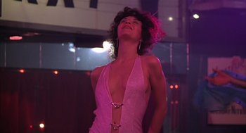 Movie still from “Melvin and Howard” (1980), directed by Jonathan Demme – A woman in a pink dress is dancing in a nightclub; Medium shot, Low angle