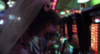 Movie still from “Melvin and Howard” (1980), directed by Jonathan Demme – A woman wearing a white dress and a veil; Close Up shot, Over the shoulder angle