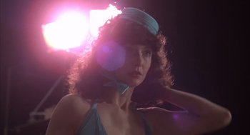 Movie still from “Melvin and Howard” (1980), directed by Jonathan Demme – A woman in a blue bathing suit and a hat; Close Up shot, Low angle