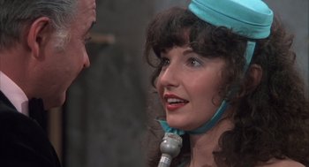 Movie still from “Melvin and Howard” (1980), directed by Jonathan Demme – A woman in a blue hat is talking to a man in a blue hat; Close Up shot, Over the shoulder angle