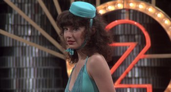 Movie still from “Melvin and Howard” (1980), directed by Jonathan Demme – A woman in a blue dress and a blue hat; Close Up shot, Over the shoulder angle