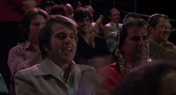 Movie still from “Melvin and Howard” (1980), directed by Jonathan Demme – A group of people sitting in a room; Close Up shot, Over the shoulder angle