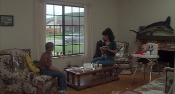 Movie still from “Melvin and Howard” (1980), directed by Jonathan Demme – Two women sitting in a living room near a window; Wide shot, High angle