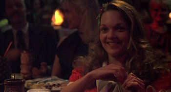 Movie still from “Melvin and Howard” (1980), directed by Jonathan Demme – A woman sitting in front of a table with food on it; Close Up shot, Over the shoulder angle