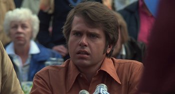 Movie still from “Melvin and Howard” (1980), directed by Jonathan Demme – A person wearing a brown shirt; Close Up shot, Low angle