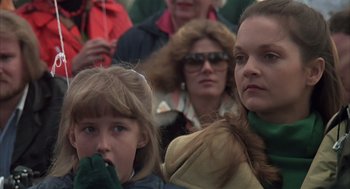 Movie still from “Melvin and Howard” (1980), directed by Jonathan Demme – A group of people standing in a crowd; Close Up shot, Over the shoulder angle