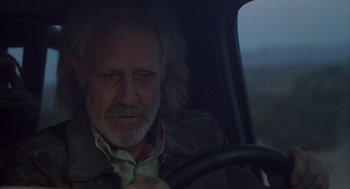 Movie still from “Melvin and Howard” (1980), directed by Jonathan Demme – An older man driving a car in the dark; Close Up shot, Low angle