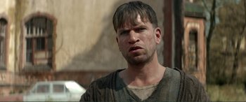 Movie still from “Men & Chicken” (2015), directed by Anders Thomas Jensen – A person wearing a shirt; Close Up shot, Low angle