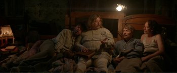 Movie still from “Men & Chicken” (2015), directed by Anders Thomas Jensen – A group of people sitting on a bed; Medium shot, High angle