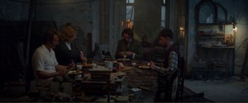 Movie still from “Men & Chicken” (2015), directed by Anders Thomas Jensen – A group of people sitting around a table eating food; Wide shot, High angle