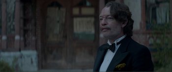 Movie still from “Men & Chicken” (2015), directed by Anders Thomas Jensen – A man in a suit and bow tie; Close Up shot, Low angle
