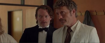 Movie still from “Men & Chicken” (2015), directed by Anders Thomas Jensen – Two men standing next to each other in front of a mirror; Close Up shot, Over the shoulder angle