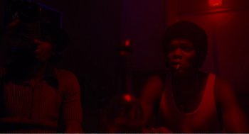 Movie still from “Menace II Society” (1993), directed by Albert Hughes – A man smoking a cigarette in a dark room; Close Up shot, Low angle