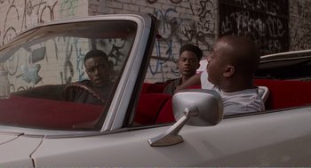 Movie still from “Menace II Society” (1993), directed by Albert Hughes – A group of young men sitting in the back seat of a car; Medium shot, Over the shoulder angle