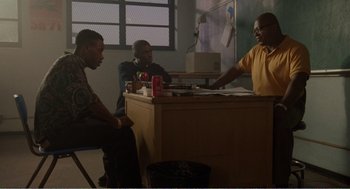 Movie still from “Menace II Society” (1993), directed by Albert Hughes – A group of men sitting at a table in front of a computer; Medium shot, Over the shoulder angle