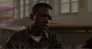 Movie still from “Menace II Society” (1993), directed by Albert Hughes – A person sitting in front of a window; Close Up shot, Over the shoulder angle