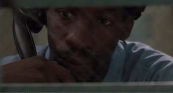 Movie still from “Menace II Society” (1993), directed by Albert Hughes – A person looking through a window; Close Up shot, High angle