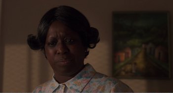 Movie still from “Menace II Society” (1993), directed by Albert Hughes – An older black woman in a floral shirt looking at the camera; Close Up shot, Low angle