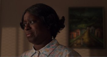 Movie still from “Menace II Society” (1993), directed by Albert Hughes – A woman in a floral shirt looking to her left; Close Up shot, Over the shoulder angle