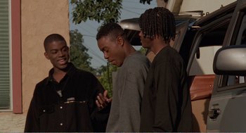 Movie still from “Menace II Society” (1993), directed by Albert Hughes – A group of young men standing next to each other; Medium shot, Low angle