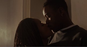 Movie still from “Menace II Society” (1993), directed by Albert Hughes – A man and a woman kissing each other in a room; Close Up shot, Low angle