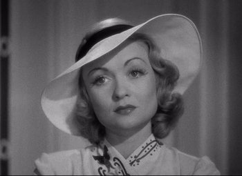 An old photo of a woman wearing a white hat