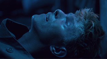 Movie still from “Merry Christmas Mr. Lawrence” (1983), directed by Nagisa Ôshima – A person laying on the ground; Close Up shot, High angle