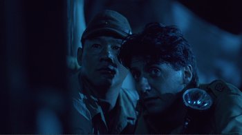 Movie still from “Merry Christmas Mr. Lawrence” (1983), directed by Nagisa Ôshima – A couple of men standing next to each other; Close Up shot, Low angle