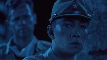Movie still from “Merry Christmas Mr. Lawrence” (1983), directed by Nagisa Ôshima – A man wearing a hat with a star on it; Close Up shot, Low angle