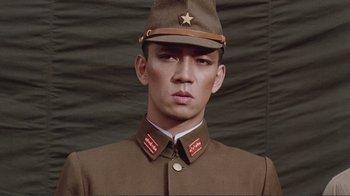 Movie still from “Merry Christmas Mr. Lawrence” (1983), directed by Nagisa Ôshima – A man in a military uniform with a star on his hat; Close Up shot, Low angle