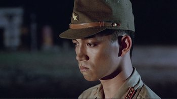 Movie still from “Merry Christmas Mr. Lawrence” (1983), directed by Nagisa Ôshima – A man wearing a hat with a star on it's brim; Close Up shot, Low angle